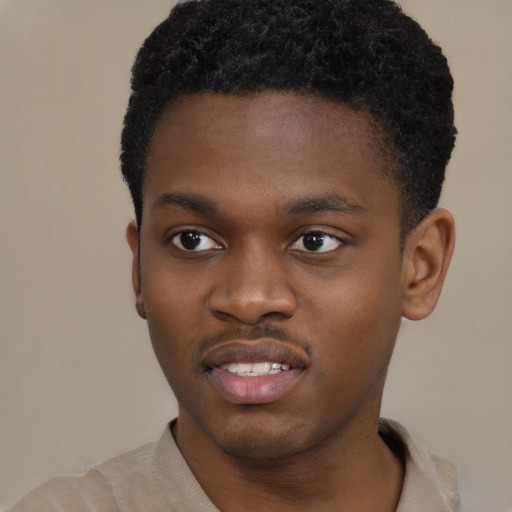 Joyful black young-adult male with short  brown hair and brown eyes