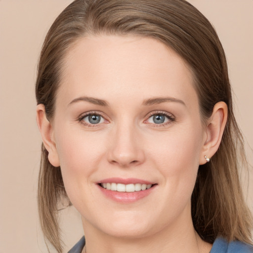 Joyful white young-adult female with long  brown hair and grey eyes