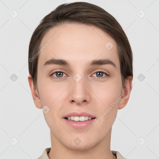 Joyful white young-adult male with short  brown hair and grey eyes