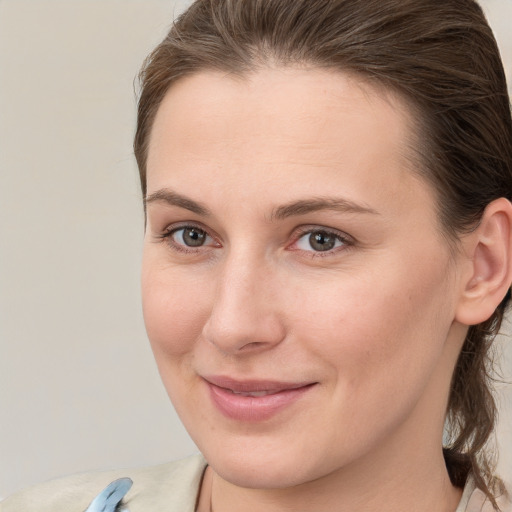 Joyful white young-adult female with medium  brown hair and grey eyes