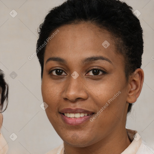 Joyful black young-adult female with short  brown hair and brown eyes