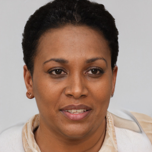 Joyful black young-adult female with short  brown hair and brown eyes