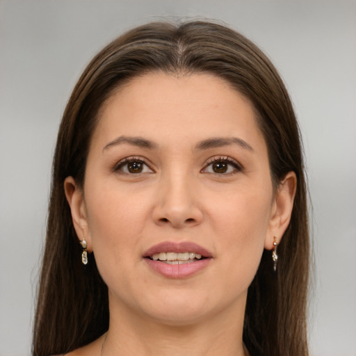 Joyful white young-adult female with long  brown hair and brown eyes