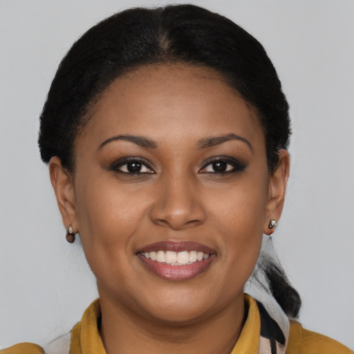 Joyful black young-adult female with medium  brown hair and brown eyes