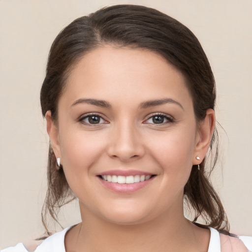 Joyful white young-adult female with medium  brown hair and brown eyes