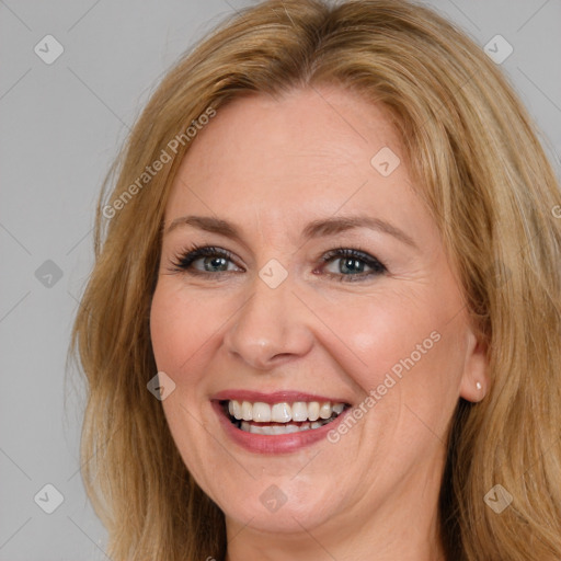 Joyful white adult female with long  brown hair and brown eyes