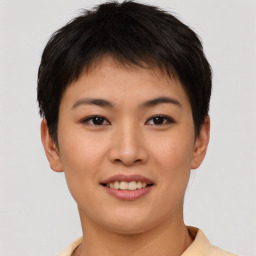 Joyful asian young-adult female with short  brown hair and brown eyes