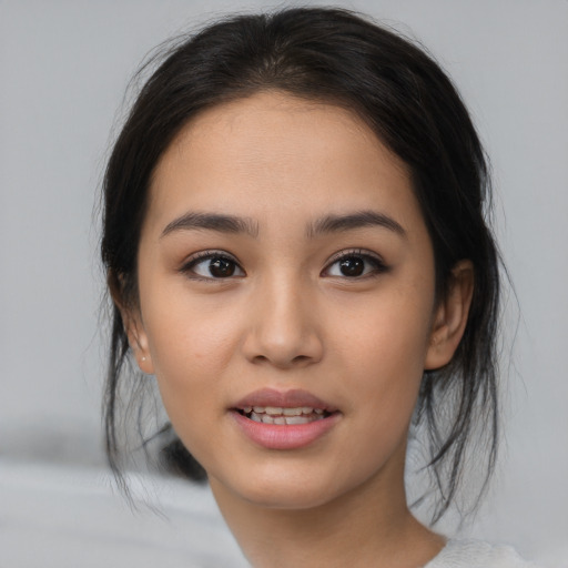 Joyful asian young-adult female with medium  brown hair and brown eyes