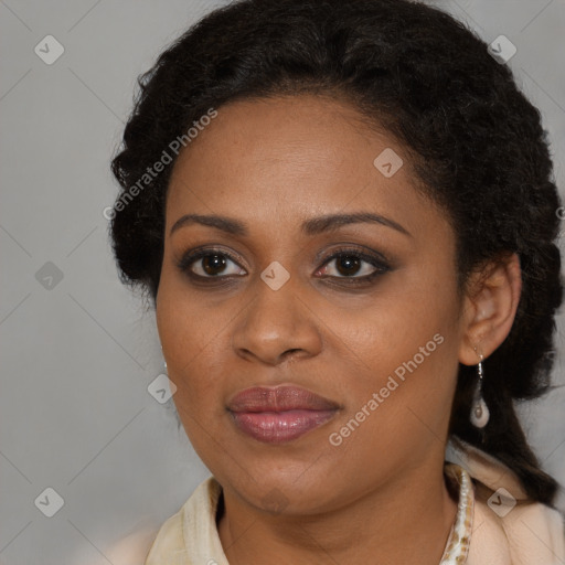 Joyful black adult female with long  brown hair and brown eyes