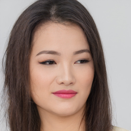 Joyful asian young-adult female with long  brown hair and brown eyes