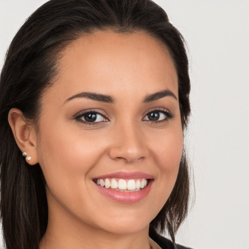 Joyful white young-adult female with long  brown hair and brown eyes