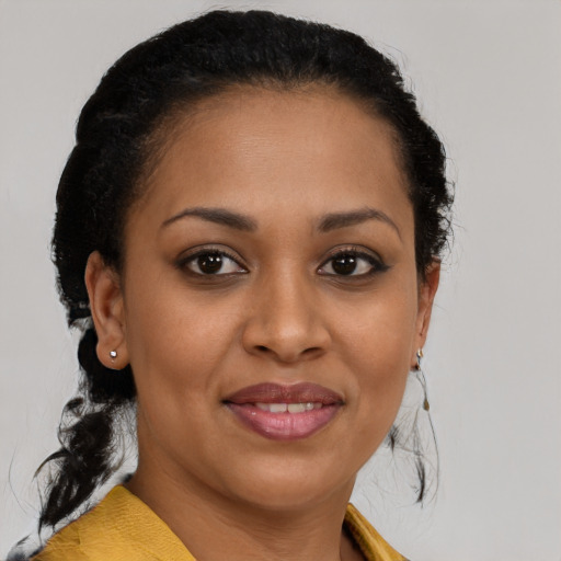 Joyful black young-adult female with medium  brown hair and brown eyes