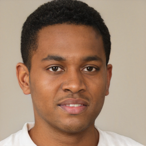 Joyful black young-adult male with short  brown hair and brown eyes
