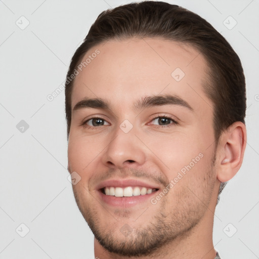 Joyful white young-adult male with short  brown hair and brown eyes