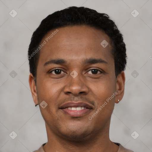 Joyful black young-adult male with short  brown hair and brown eyes