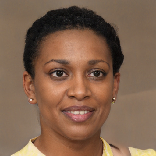 Joyful black adult female with short  brown hair and brown eyes