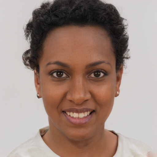 Joyful black young-adult female with short  brown hair and brown eyes