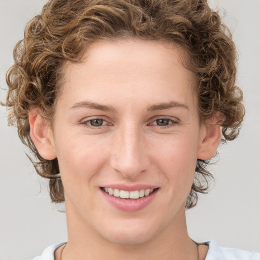 Joyful white young-adult female with medium  brown hair and blue eyes