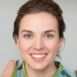 Joyful white young-adult female with medium  brown hair and green eyes