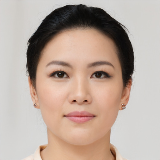 Joyful asian young-adult female with medium  black hair and brown eyes