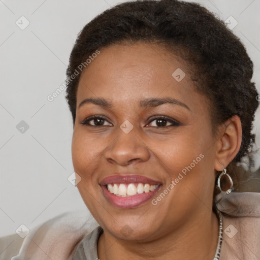 Joyful black young-adult female with short  brown hair and brown eyes