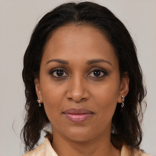 Joyful black young-adult female with medium  brown hair and brown eyes