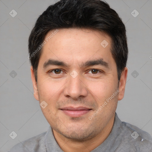 Joyful white adult male with short  black hair and brown eyes