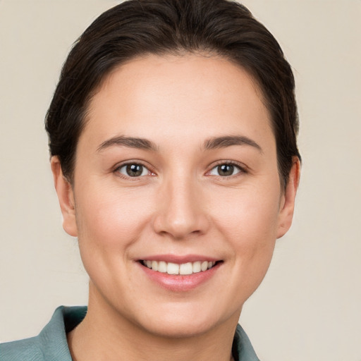 Joyful white young-adult female with short  brown hair and brown eyes