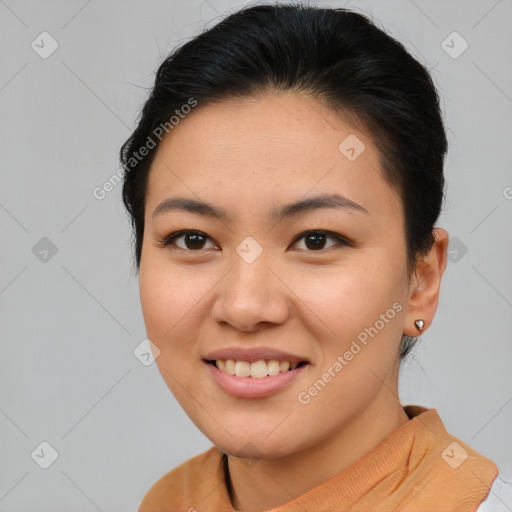 Joyful latino young-adult female with short  brown hair and brown eyes