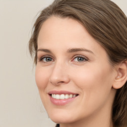 Joyful white young-adult female with long  brown hair and green eyes