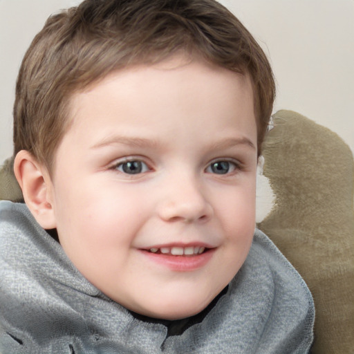 Joyful white child male with short  brown hair and blue eyes