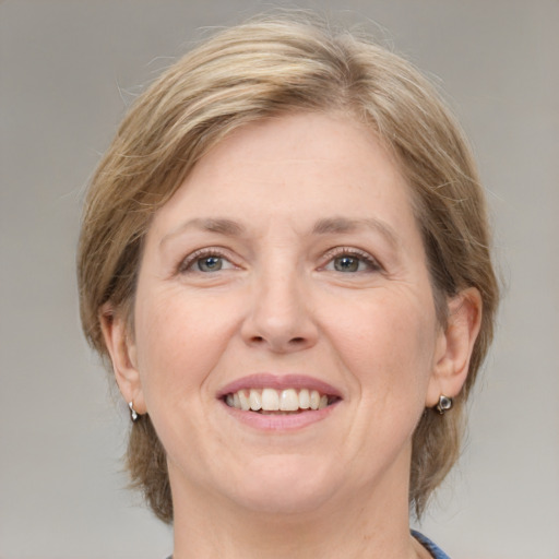 Joyful white adult female with medium  brown hair and grey eyes