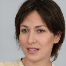 Joyful white adult female with medium  brown hair and brown eyes