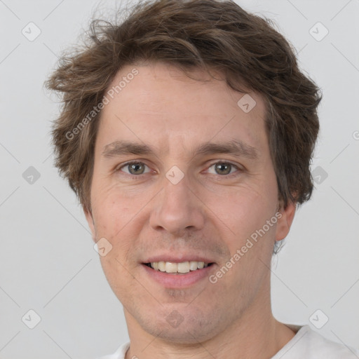 Joyful white adult male with short  brown hair and grey eyes