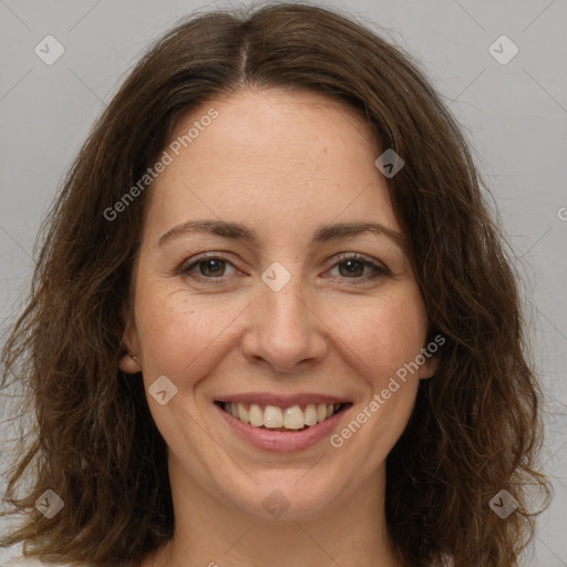 Joyful white adult female with long  brown hair and brown eyes