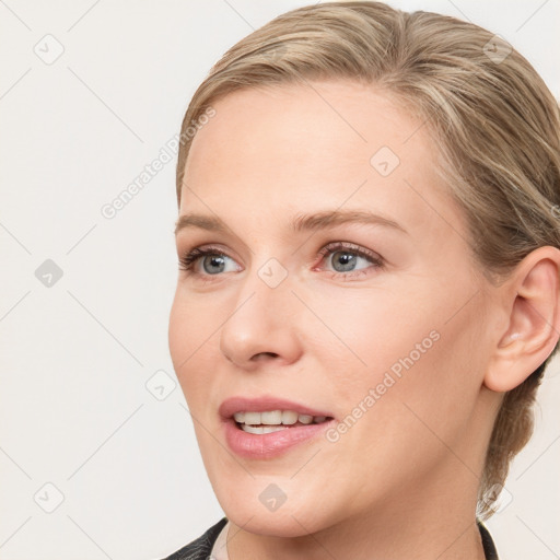 Joyful white young-adult female with medium  brown hair and blue eyes