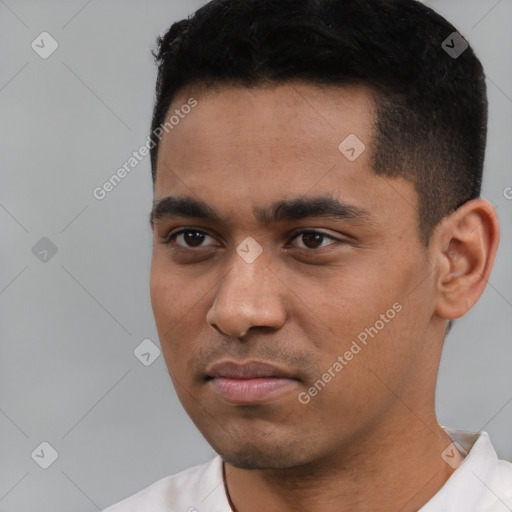 Joyful white young-adult male with short  black hair and brown eyes