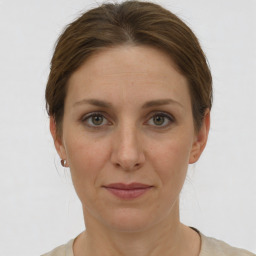 Joyful white adult female with short  brown hair and grey eyes