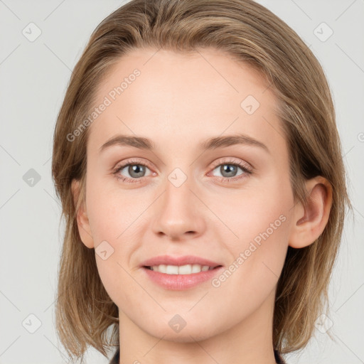 Joyful white young-adult female with medium  brown hair and blue eyes