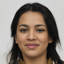 Joyful latino young-adult female with long  brown hair and brown eyes