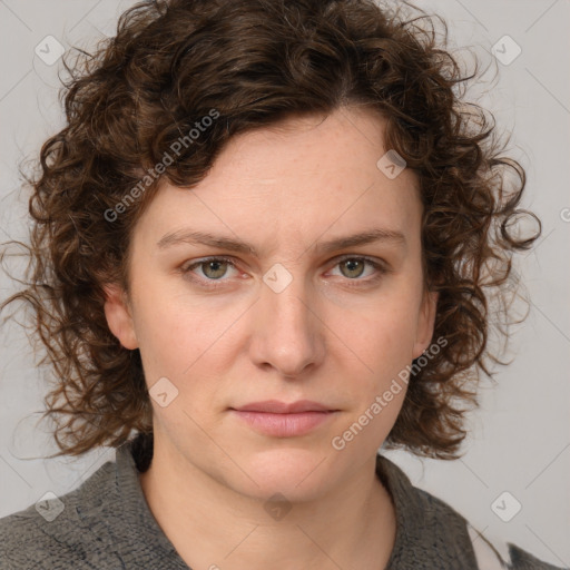 Joyful white young-adult female with medium  brown hair and blue eyes