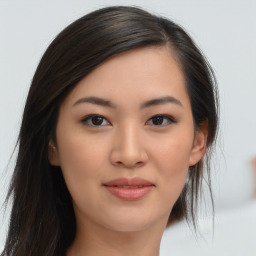 Joyful asian young-adult female with long  brown hair and brown eyes