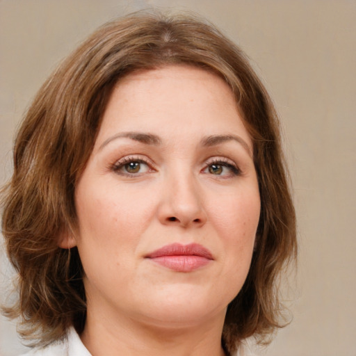 Joyful white young-adult female with medium  brown hair and green eyes