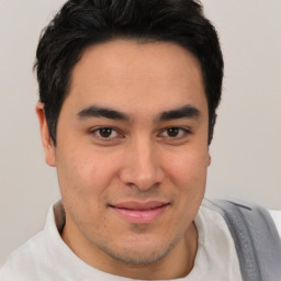 Joyful latino young-adult male with short  brown hair and brown eyes