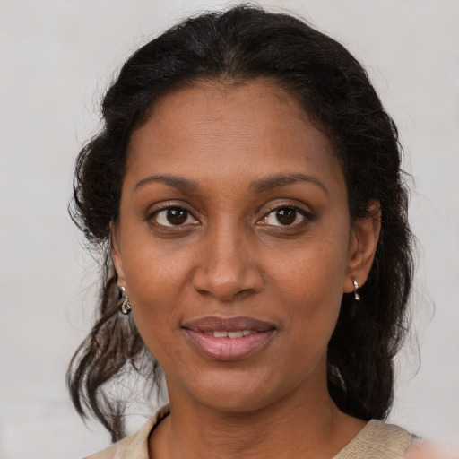 Joyful black young-adult female with medium  brown hair and brown eyes