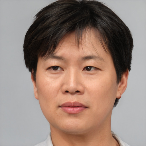 Joyful asian adult female with short  brown hair and brown eyes
