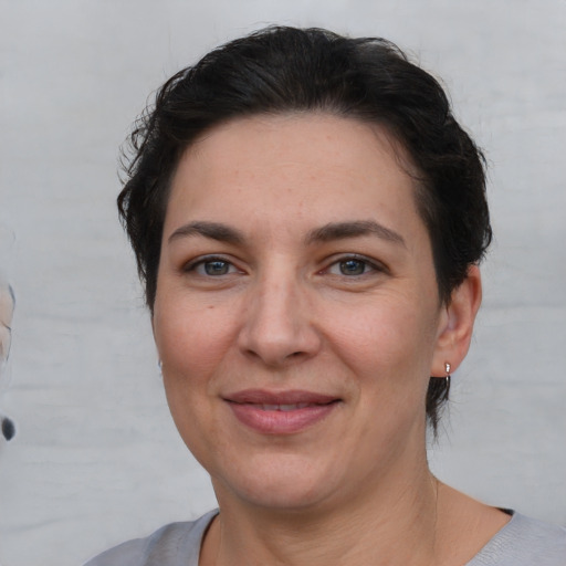 Joyful white adult female with short  brown hair and brown eyes