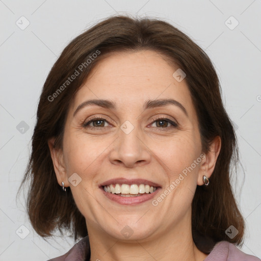 Joyful white adult female with medium  brown hair and brown eyes