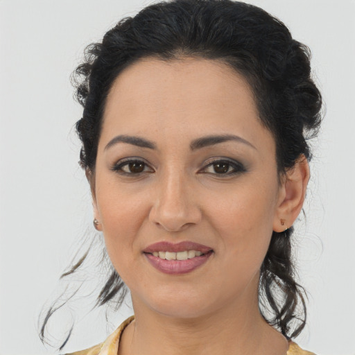 Joyful latino young-adult female with medium  brown hair and brown eyes