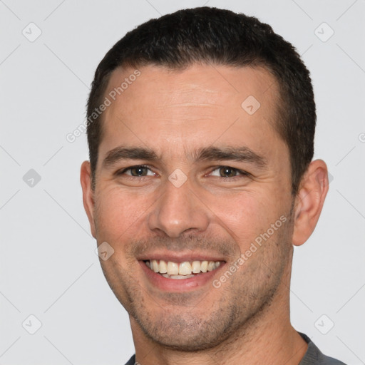 Joyful white young-adult male with short  brown hair and brown eyes